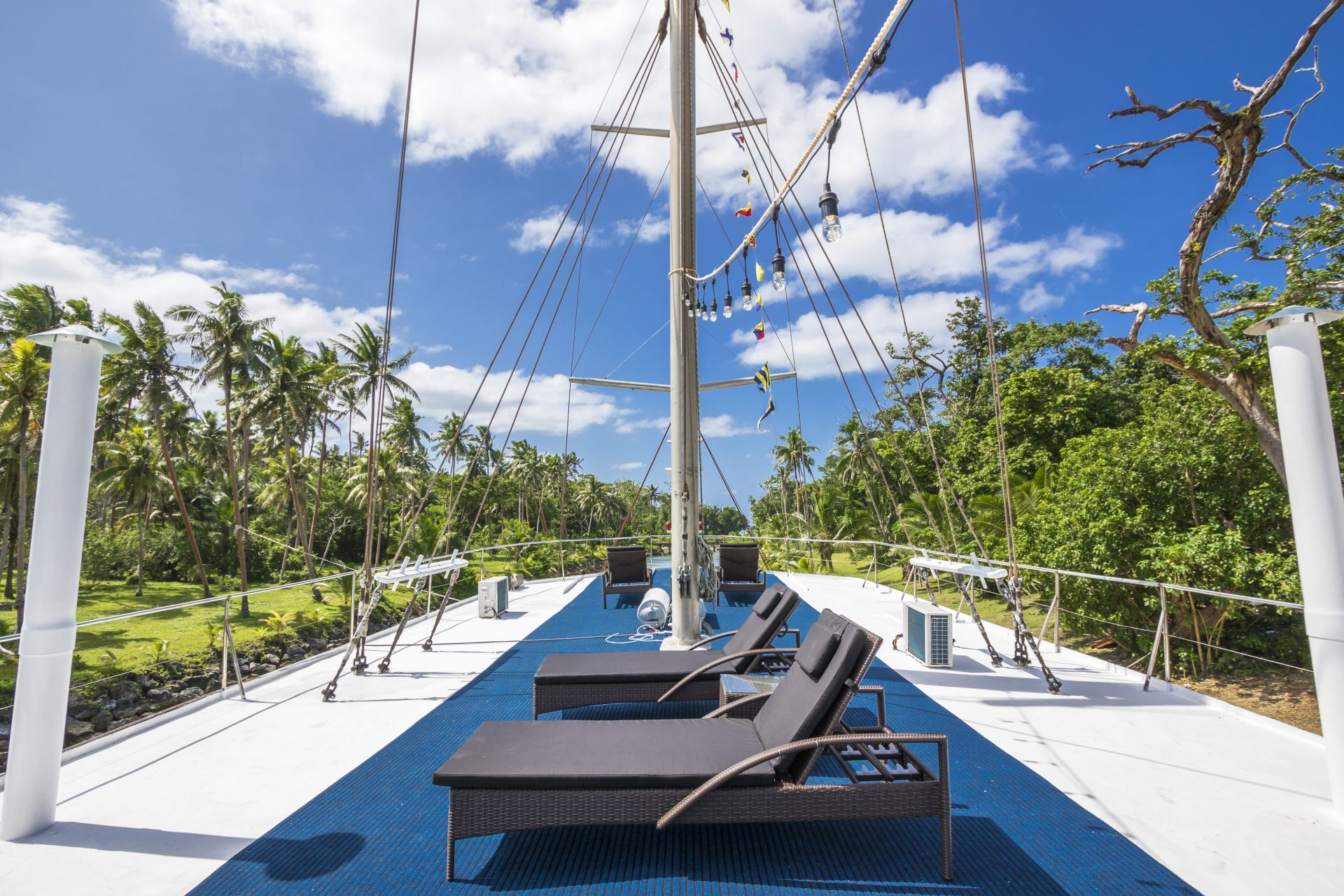 sun loungers on deck of tropical yacht